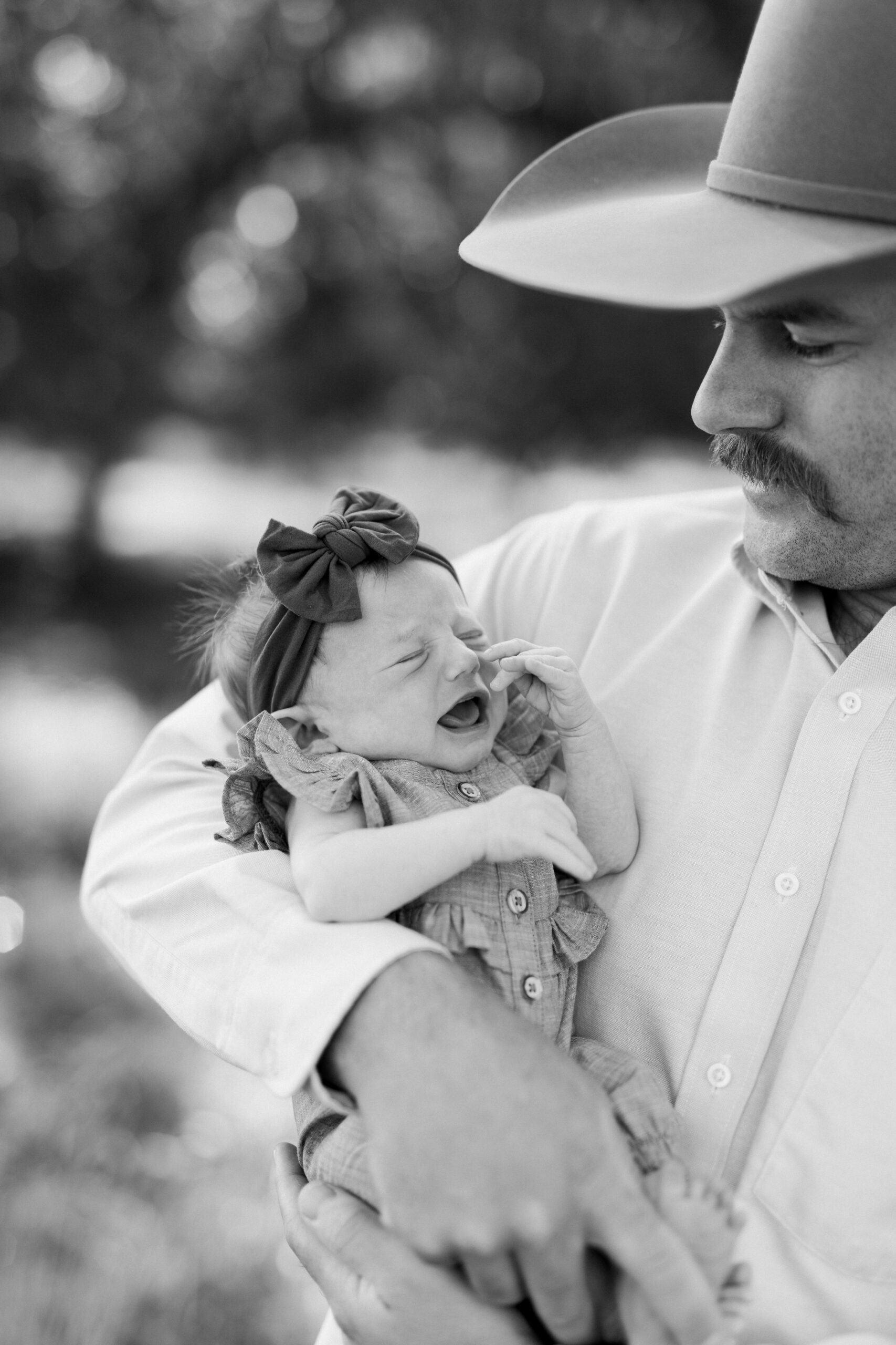 Rancher and dad holding his baby girl.